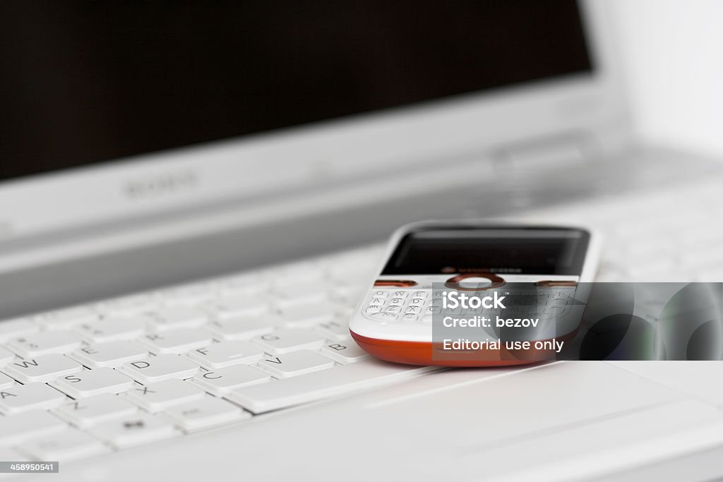 Business concept Veliko Tarnovo, Bulgaria; March 19, 2012: Vodafone phone on laptop Sony Vaio keyboard Black Color Stock Photo