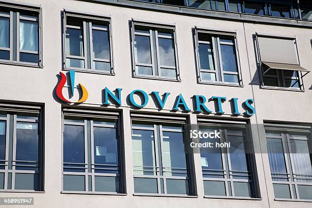 House Facade With Novartis Neon Sign Stock Photo - Download Image Now - Sign, Blue, Building Exterior