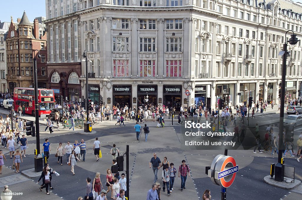 Shoppers in Oxford Circus, London "London, United Kingdom - October 1, 2011: Elevated view from a shop of pedestrians crossing the traffic junction between Oxford Street and Regent Street known as Oxford Circus. The underground sign of the bottom right is for Oxford Circus station. Oxford Street is Europe's busiest shopping street and home to many department and flagship stores, as a result it's a popular tourist attraction." Oxford Street - London Stock Photo