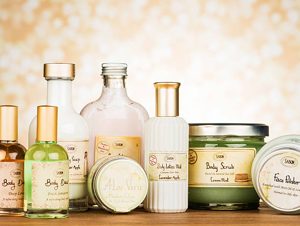 Front view of various shower products such as a shampoo, a pumice stone, a towel, a bath sponge and a bar of soap isolated on white background. Some products are on a basket.