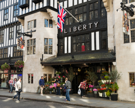 London, UK - September 29, 2012: People on the street outside the entrance to Liberty in London's West End.  Liberty is a department store that was established in 1875.
