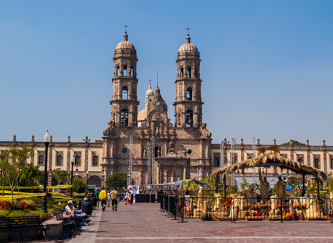 Guadalajara, Mexico - December 18, 2008: Basilica de la Virgen de Zapopan. People can be seen in the park in the foreground of the image and near a nativity scene set up in the lead up to Christmas.