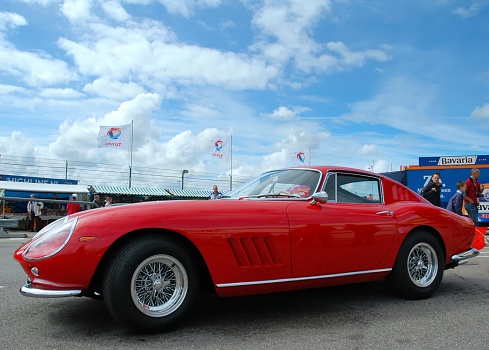 Zandvoort, The Netherlands - June 20, 2004: Classic Ferrari 275 GTB sports car in the paddock of the Zandvoort racing circuit. People in the background are looking at the cars.