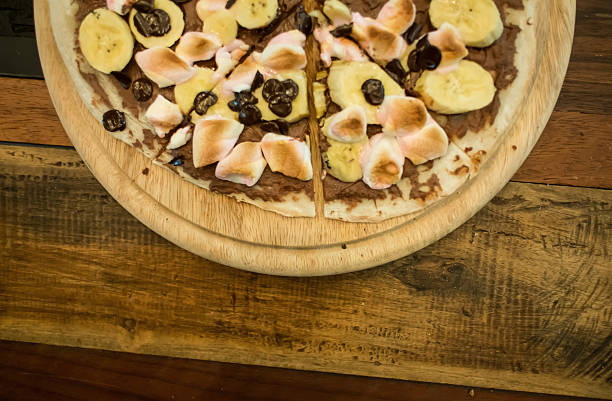 istock Dessert pizza with chocolate banana and marshmallow. 458954019