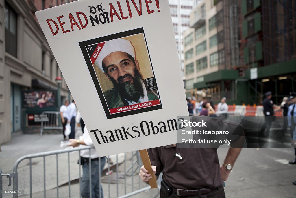 Terrorism Dead not Alive Osama Bin Laden "New York, USA - september 11th 2011: a man holding a sign to express his gratitude to United States President Barack Obama for capturing and killing Osama Bin Laden." Osama Bin Laden Stock Photo