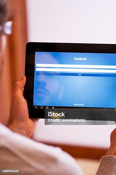 Facebook Homepage Displayed On An Tablet Stock Photo - Download Image Now - Computer Monitor, Looking Over Shoulder, Men