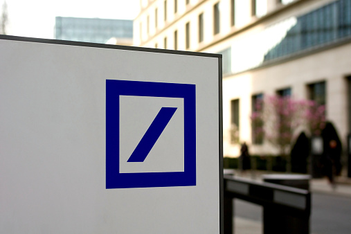 Frankfurt, Germany - April 3, 2012: The Deutsche Bank logo in front of the Deutsche Bank Tower in Frankfurt.