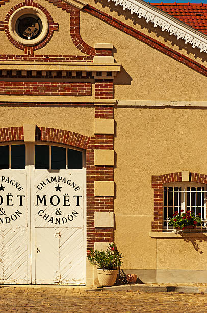 Moet et Chandon factory "A!remant, France - August 27, 2012: Moet et Chandon factory doors in the village of Cremant. This is where the grapes are taken after harvest to be juiced and bottled before becoming champagne." moet chandon stock pictures, royalty-free photos & images