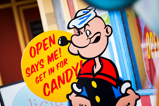 Halifax, Nova Scotia, Canada - December 13, 2011: The Freak Lunchbox candy store Popeye signage.  This sign and slogan is visible just outside the front entrance on Barrington Street in downtown Halifax.  Freak Lunchbox was founded in 2001 and has become an iconic location in downtown Halifax. The store sells unique and retro candy as well as toys, collectibles, and beverages. Currently (as of 2011) there are three locations with two in Nova Scotia and one in Saint John, New Brunswick, Canada.