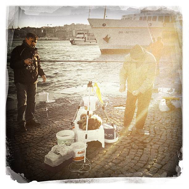 uomo pesca su karakoy district. - mobilestock istanbul turkey day foto e immagini stock