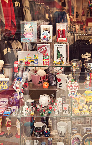 New York Souvenirs and Gifts "New York, New York, USA - November 25, 2012: Souvenirs displayed at the gifts shop in New York City located by Time Square in Midtown Manhattan. Selling yellow taxi toys, shot glasses, mugs, clothes with New York logo." new york state license plate stock pictures, royalty-free photos & images