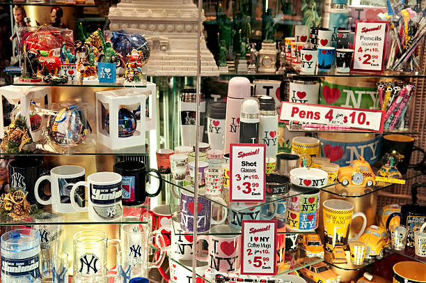 New York Souvenirs and Gifts "New York, New York, USA - November 25, 2012: Souvenirs displayed at the gifts shop in New York City located by Time Square in Midtown Manhattan. Selling yellow taxi toys, shot glasses, mugs with New York logo." new york state license plate stock pictures, royalty-free photos & images