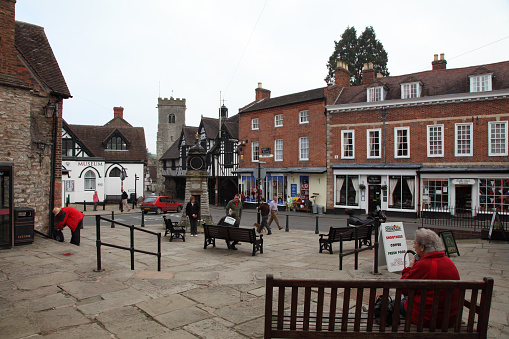 Much Wenlock, Shropshire, UK - May 21, 2012: People gather in Much Wenlock Town Square.