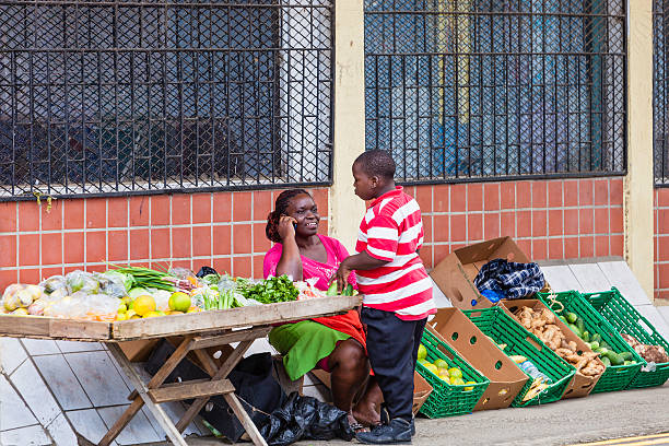 Dili / Timor Leste - July 26, 2018: young Timorese farmers selling vegetables at the supermarket door