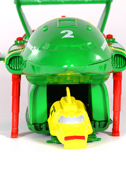 Vancouver, Canada - January 29, 2012: Thunderbird 4 launching from Thunderbird 2, from the Thunderbirds television series, against a white background. The toy is from Matchbox.