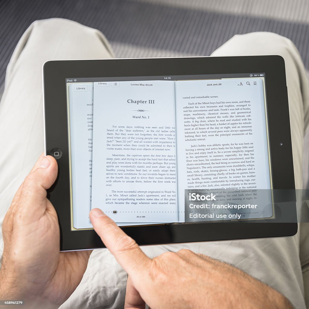 Man scrolling the pages of an ebook with Ipad "Florence, Italy - September 8, 2012: Man sitting on the sofa is holding an ipad 3 and reading an ebook downloaded from the itunes. Right hand finger is scrolling a page of the ebook. The ipad 3 is the new device made by apple inc." Big Tech Stock Photo