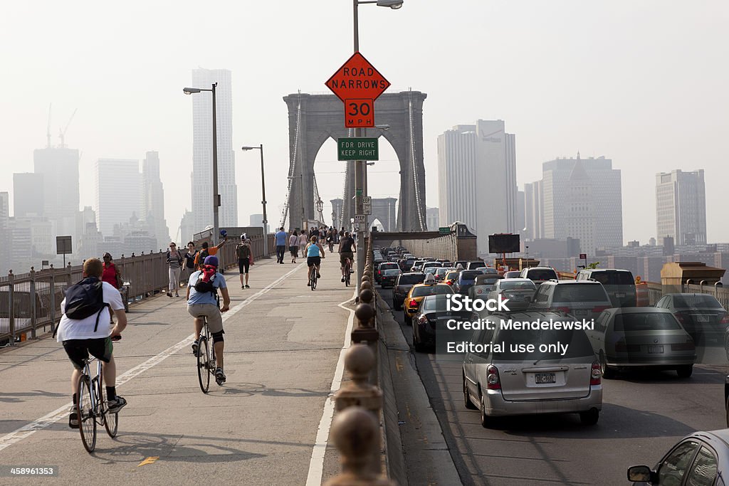 Brooklyn Bridge "New York City, USA - May 26, 2011: Brooklyn bridge on a hazy day looking towards Manhattan with people walking, cycling and driving over the bridge. During this time the bridge was under construction." Bridge - Built Structure Stock Photo