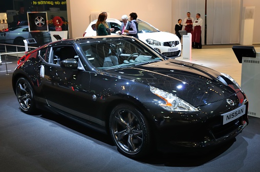Brussels, Belgium - January 10, 2012: Nissan 370Z coupe sports car on display during the 2012 Brussels motor show. People in the background are looking at the cars.