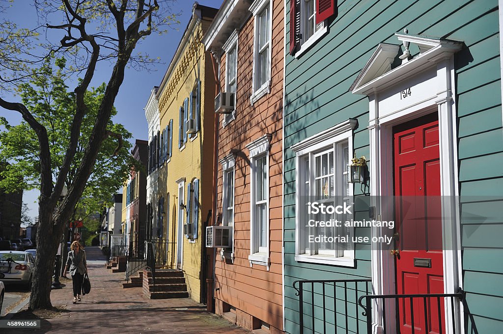 Lady Walking in Georgetown "Washington, DC, USA - April 9, 2012. A lady walking in the neighborhood of Georgetown. Georgetown is a historic district in Washington, DC. It is located on north of the Potomac River. Georgetown attracts lots of visitors for its upscale shops, bars and restaurants." Adult Stock Photo