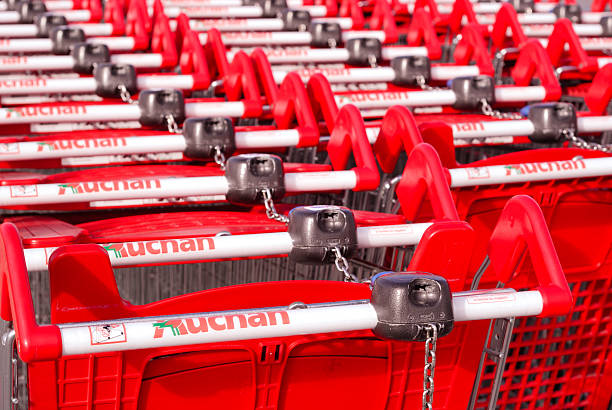 Shopping Carts at an Auchan Supermarket, France "Angouleme, France - January 27, 2012: Shopping Carts. The image shows a closeup of shopping carts belonging to the French multinational supermarket chain Auchan. The company opened its first store in France in 1961 and now has over 3000 around the world. It has more than 200,000 employees globally including over 5000 in France." chariot photos stock pictures, royalty-free photos & images