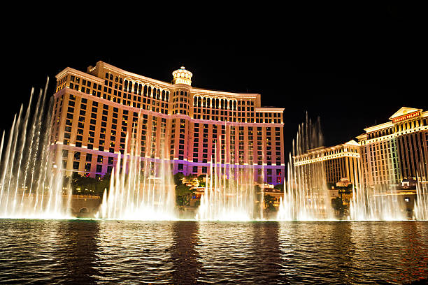 Bellagio Hotel Cacino and Caesars Palace Las Vegas USA "Las Vegas, Nevada, USA - September 16th, 2012: View of the Bellagio Hotel and Casino, Las Vegas, with the famous fountain show with the Pink Panter them by Henry Mancini. Bellagio fountains are one of Las Vegas's premier attractions. Caesars Palace on the right." bellagio stock pictures, royalty-free photos & images
