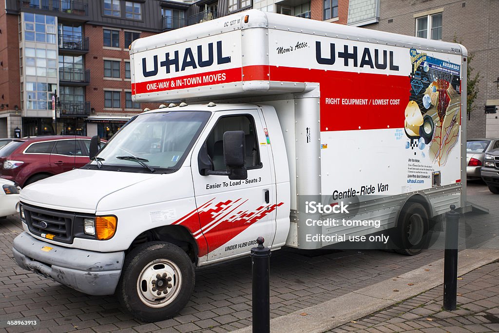 U-Haul Van Halifax, Nova Scotia, Canada - November 2, 2012: U-Haul Van parked in a parking lot and in use.  Rear of van is open with ramp down.  Other vehicles and apartment and office buildings are visible in background and around vehicle. Truck Stock Photo