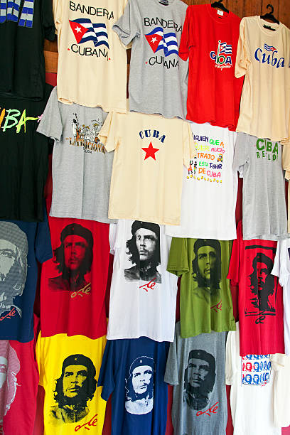Cuba t-shirts "Havana, Cuba - February 19, 2013: Cuba and Che Guevara t-shirts in different colors displayed at a boutique window at Havana streets." cuba market stock pictures, royalty-free photos & images