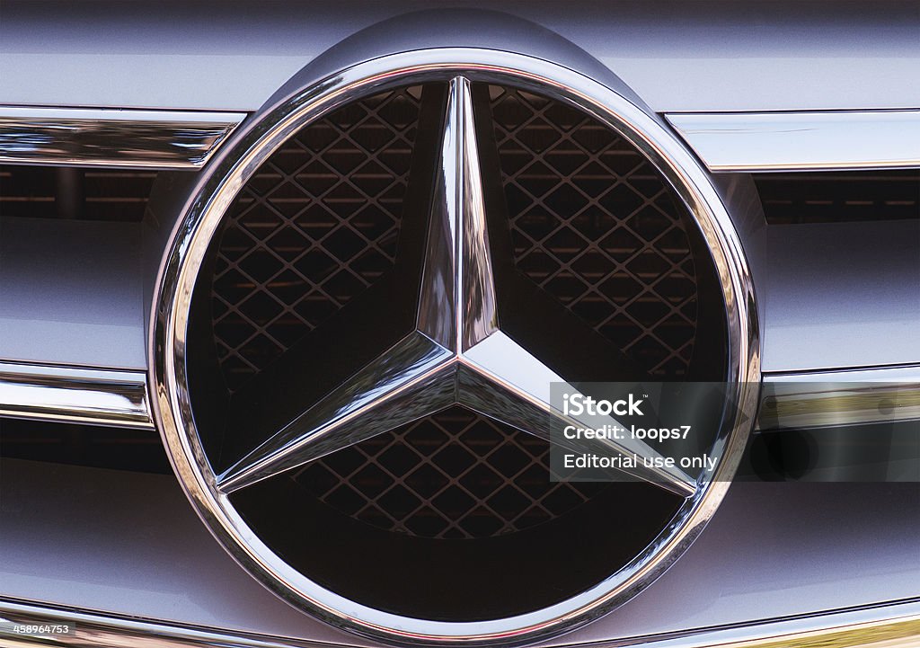 Mercedes-Benz logo "Bassano del Grappa, Italy - February 17, 2012: Close-up of the three-pointed star logo and chrome grille detail from a C-Class Mercedes-Benz." Mercedes-Benz Stock Photo