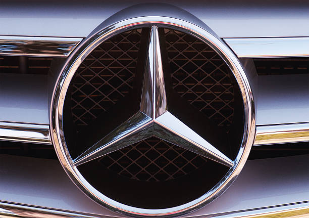 Mercedes-Benz logo "Bassano del Grappa, Italy - February 17, 2012: Close-up of the three-pointed star logo and chrome grille detail from a C-Class Mercedes-Benz." mercedes benz photos stock pictures, royalty-free photos & images
