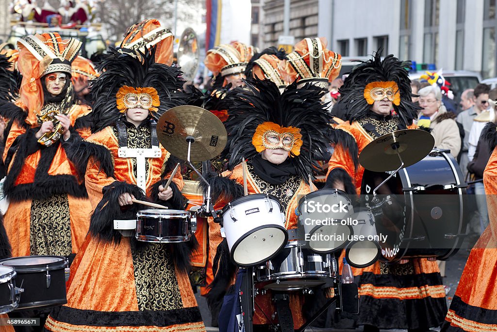 Rosenmontagszug, Street carnival on Rose Monday in Mainz, German "Mainz, Germany - February 20, 2012: The Rosenmontagszug (carnival parade) moves through the streets of Mainz, Germany. A group of costumed musicians marching down the street, playing on music instruments. Rosenmontagszug in Mainz is one of the largest and most famous carnival parades in Germany with approx. 500.000 spectators" Carnival - Celebration Event Stock Photo