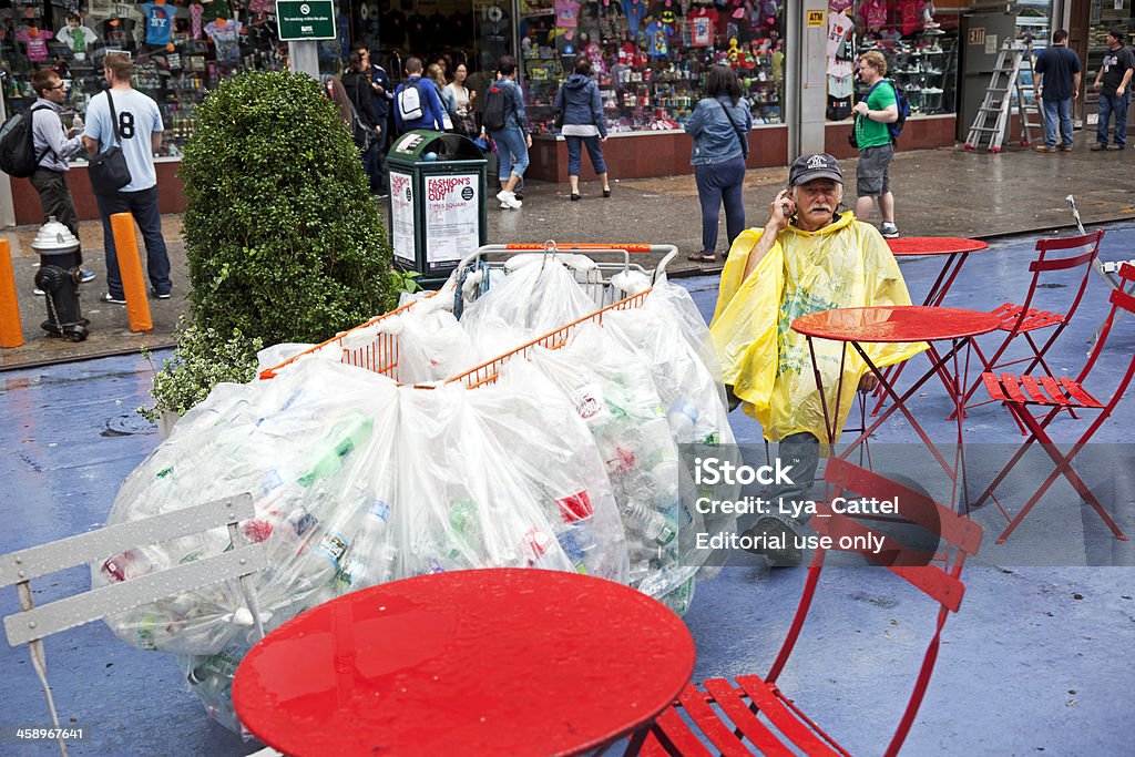 Collecting plastic bottles "New York City, USA - September 7, 2011: Workman has collected plastic bottles from the waste for recycling at Times Square. The plastic bottles are sorted into many plastic bags in his shopping cart, after work he's resting on a chair." Adult Stock Photo