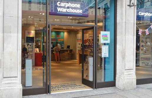 London, UK - August 20, 2012: Carphone Warehouse is a large British based and Stock Market listed, mobile phone company. It has over 1700 stores across Europe and in this Oxford Street store two customer can be seen being served by one of the companies 4000 staff.    