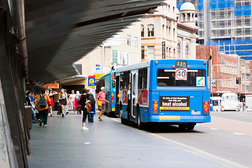 Sydney, Australia - March 21, 2012: The Sydney main Central Bus terminal. Commuters at the bus station getting on and of the bus and some of them still waiting for their journey.