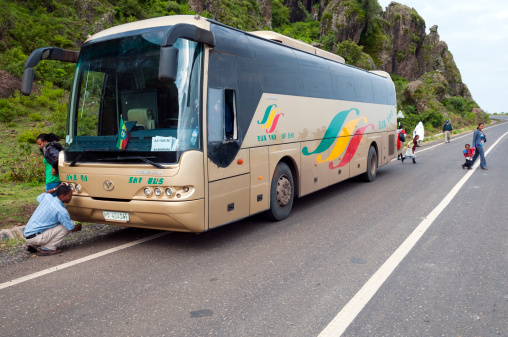 bus moves on the road against the background of mountains
