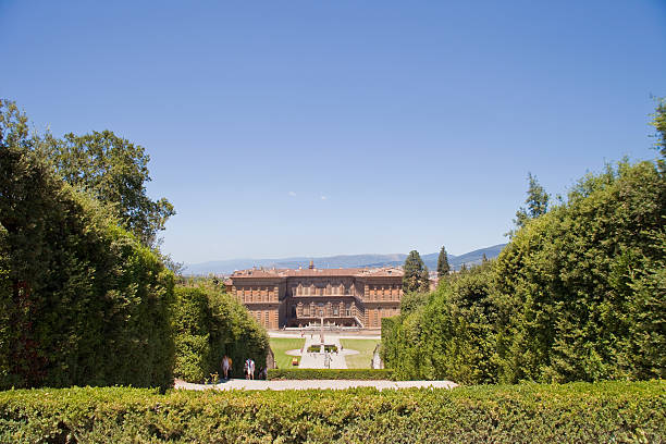 Pitti Palace "Florence, Italy - July 17, 2012. From the pathway en route to the Silver Museum and Porcelain Museum, this photo looks downhill toward the Palazzo Pitti and a view of Florence. Several people are walking on the path in the Boboli Gardens." giardini di boboli stock pictures, royalty-free photos & images