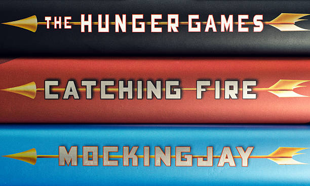Hunger Games Trilogy "Halifax, Canada - March 24, 2012: A close up the spines of the three books in The Hunger Games Trilogy from author Suzanne Collins." book title stock pictures, royalty-free photos & images