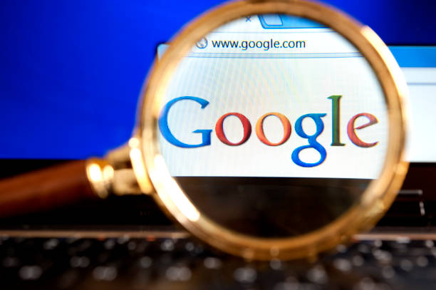 Google website through a magnifying glass "Izmir, Turkey - June 11, 2012: Close up to Google  website through a magnifying glass on the laptop. Google is the most popular search engine in the world." google brand name photos stock pictures, royalty-free photos & images