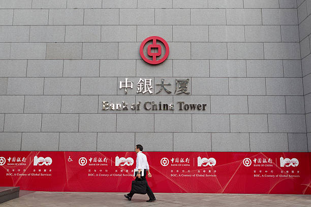Bank of China Tower in Hong Kong "Hong Kong, China - September 6, 2012: A man walks past Bank of China Tower in Central District, Hong Kong. This year is 100th anniversary of Bank of China." the bank of china tower stock pictures, royalty-free photos & images