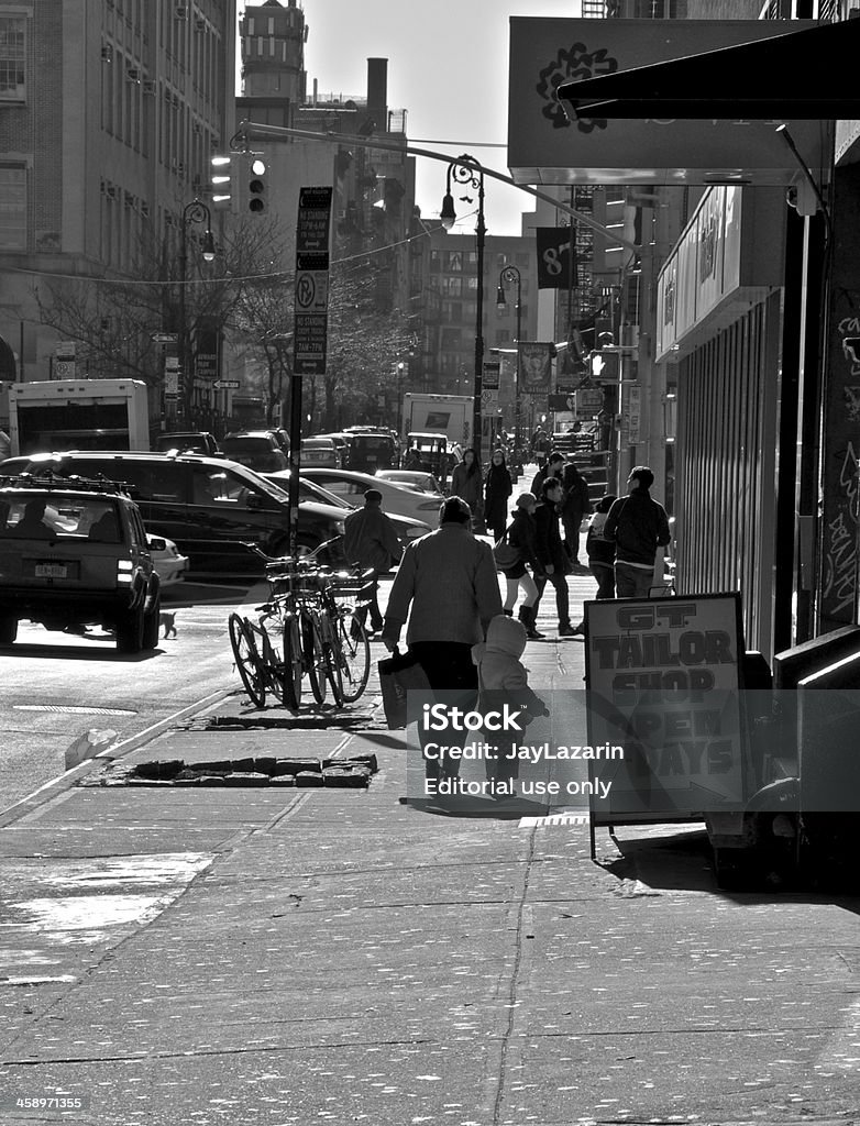 Lower East Side of Manhattan street scene, New York City "New York City, USA - January 07, 2012: A woman and child and others are seen walking along Ludlow Street near Grand Street in Manhattan's historic Lower East Side." Lower East Side Manhattan Stock Photo