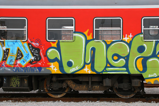Nova Gorica, Slovenia-March 18th, 2012: colourful graffiti on train wagon, waiting for passengers on railway station
