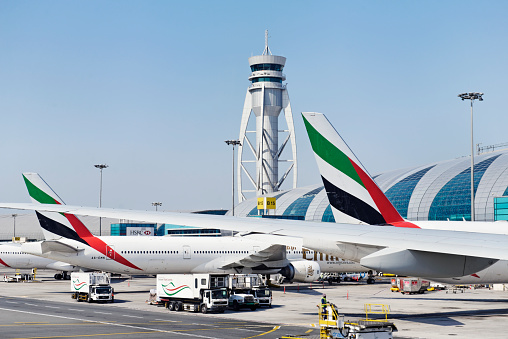 Dubai, United Arab Emirates - January 24, 2013:A Boeing 777 from Emirates Airline is docked at a gate of the new Terminal 3. A service catering  staff is nearby the airplane.