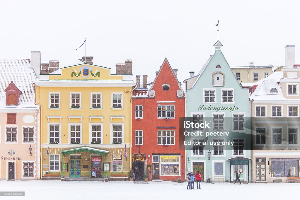 Winter in old town. "Tallinn, Estonia - March 4, 2013: Colorful buildings at Town Hall Square in old town during heavy snowfall." Street Stock Photo