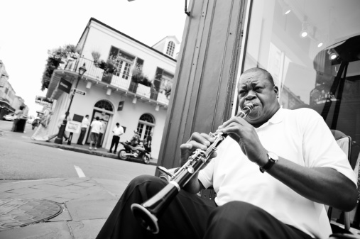 New Orleans, Louisiana, USA - May 8, 2012: An African-American street musician plays clarinet on a street corner in the French quarter of New Orleans. The city has a rich musical tradition and is considered to be the birthplace of Jazz music.