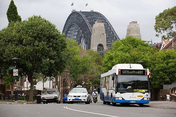 ônibus e táxi com a sydney harbour bridge - bus public transportation sydney australia australia - fotografias e filmes do acervo