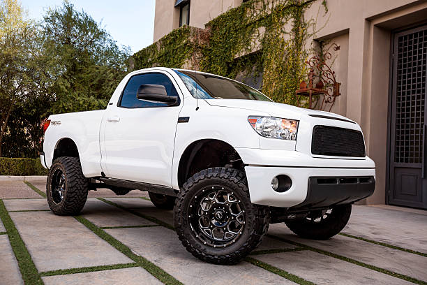 Toyota Tundra 2008 "Scottsdale, United States - February 16, 2012: A photo of a parked white 2008 Toyota Tundra pick up truck, the Tundra is the largest truck made by Toyota and this model features a lift kit with custom suspenion and wheels." tacoma photos stock pictures, royalty-free photos & images