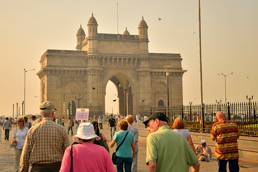 Mumbai, India - April 15, 2012: Tourist are streaming to the Gateway of India Monument during an early morning shore excursion from the Ocean Princess cruise ship docked at Mumbai India.
