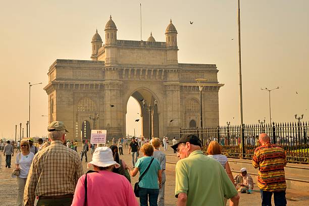 Streaming To The Gateway of India Mumbai, India - April 15, 2012: Tourist are streaming to the Gateway of India Monument during an early morning shore excursion from the Ocean Princess cruise ship docked at Mumbai India. maharashtra stock pictures, royalty-free photos & images