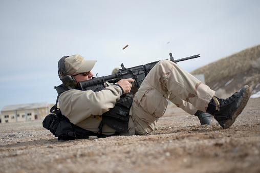 Salt Lake City, United States - February 18, 2012: A member of the Draper City Police department demonstrates how to properly handle and fire an AR-15 style rifle from a ground position.  