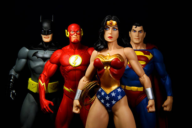 Team "Vancouver, Canada - October 9, 2012: Action figure models of Wonder Woman, The Flash, Superman and Batman, released by DC comics, against a black background." action figure photos stock pictures, royalty-free photos & images