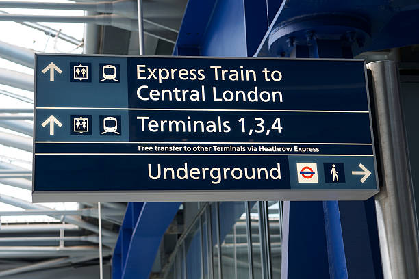 Heathrow Terminal 5 sign "London, United Kingdom - April 8, 2012: Sign in London Heathrow Airport Terminal 5 directing passengers towards the Underground system and trains to the city centre" paris metro sign stock pictures, royalty-free photos & images